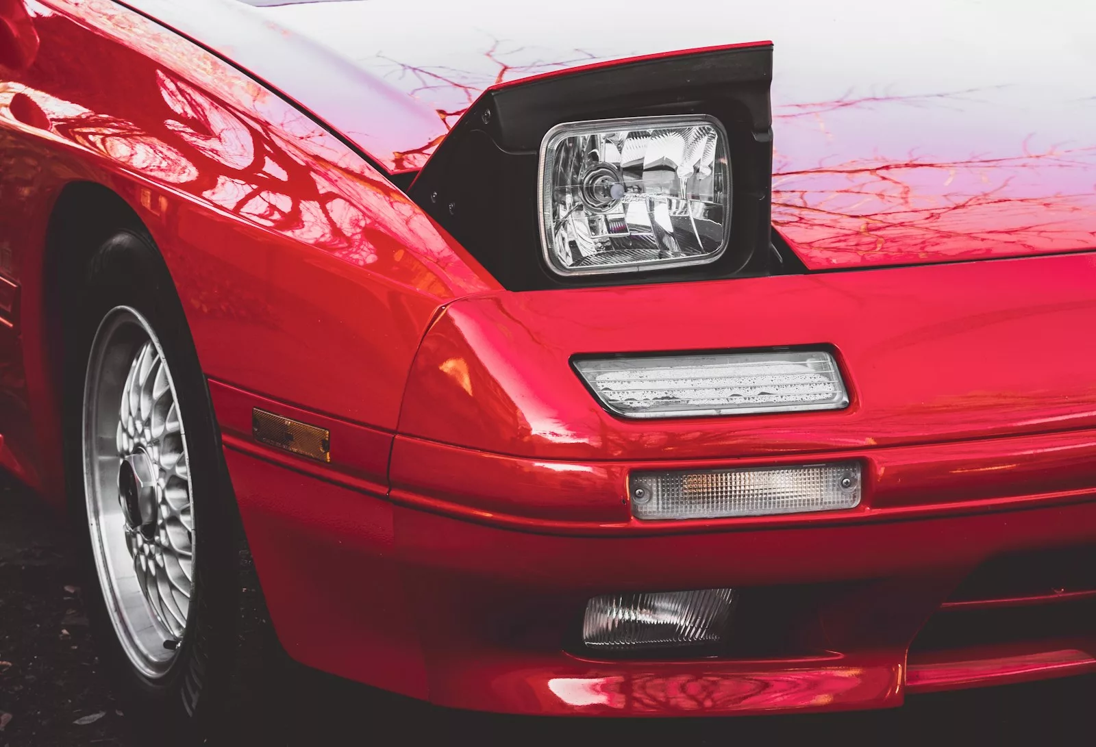 red Mazda RX-7 car on snow covered ground during daytime